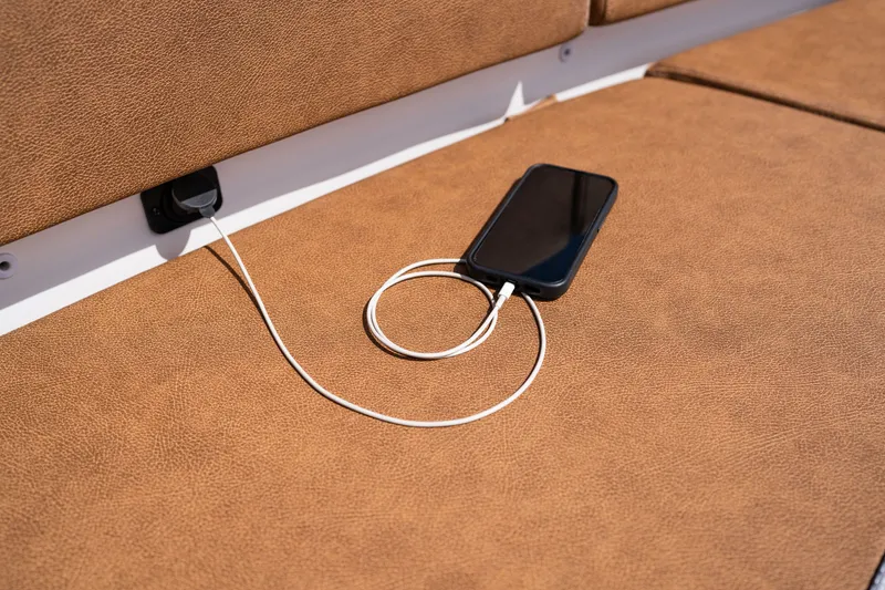 Slide: The Image of Phone charging on Sea Hunt Ultra 305SE boat's brown leather seat, 2026 model. - 30
