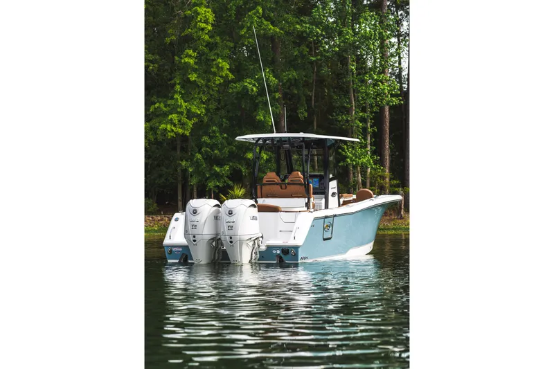 Slide: The Image of 2026 Sea Hunt Ultra 305SE boat with dual engines on a serene lake. - 4