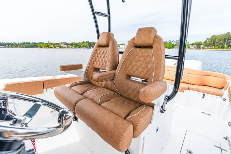 Slide: The Image of Luxurious seating on 2026 Sea Hunt Ultra 305SE boat with scenic water backdrop. - 13