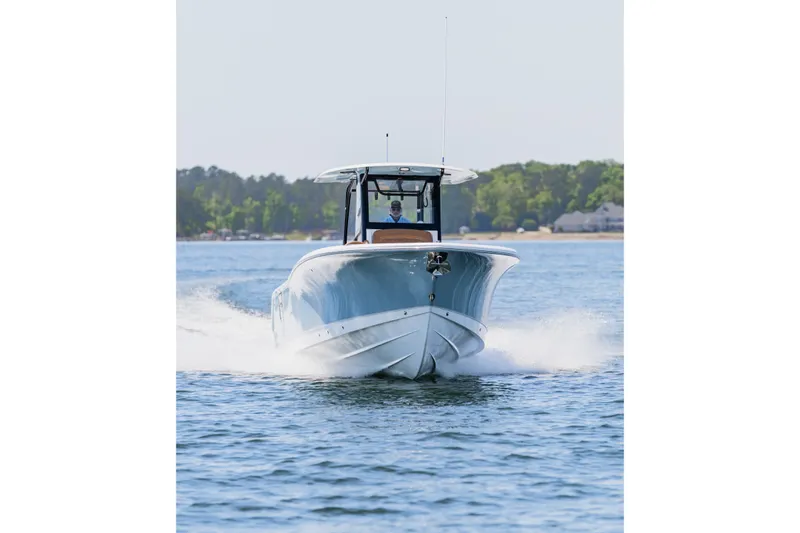 Slide: The Image of 2026 Sea Hunt Ultra 305SE boat cruising on a serene lake. - 31