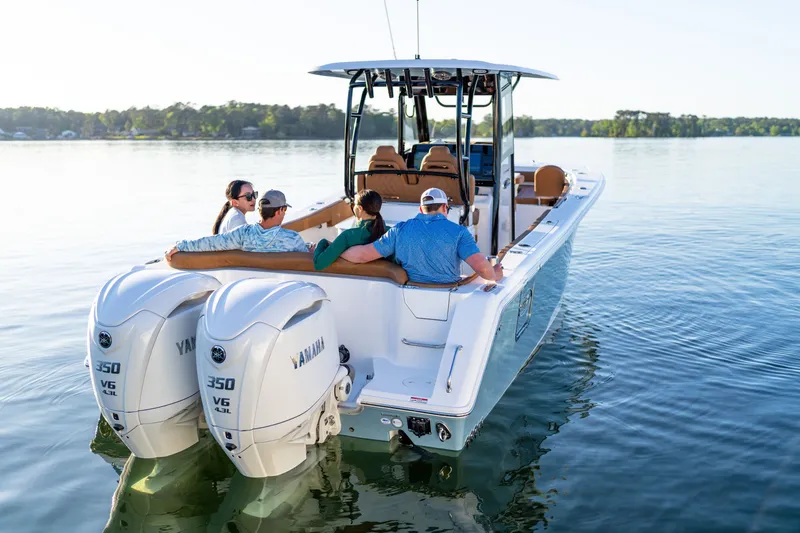 Slide: The Image of 2026 Sea Hunt Ultra 305SE boat with Yamaha engines on a serene lake. - 43
