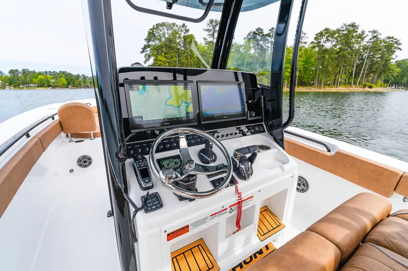 Slide: The Image of 2026 Sea Hunt Ultra 305SE boat dashboard with navigation screens and controls. - 11