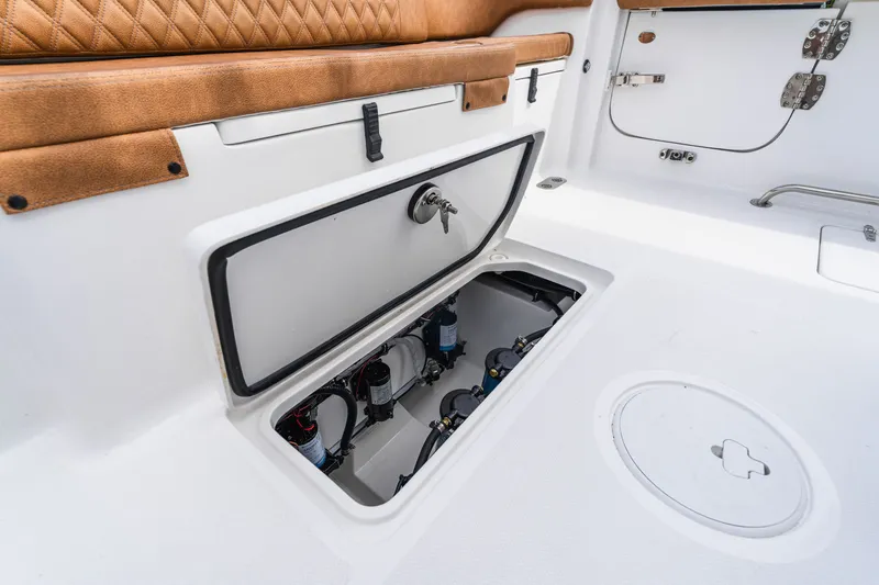 Slide: The Image of Storage compartment on 2026 Sea Hunt Ultra 305SE boat with tan seating. - 26