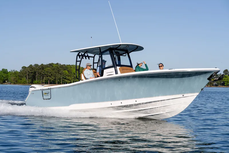Slide: The Image of 2026 Sea Hunt Ultra 305SE boat cruising on a serene lake with passengers onboard. - 39
