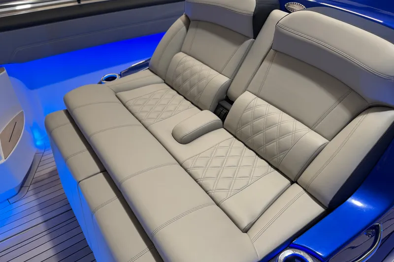 Slide: The Image of Luxurious seating in the 2027 Nor-Tech 450 Sport boat with blue ambient lighting. - 23