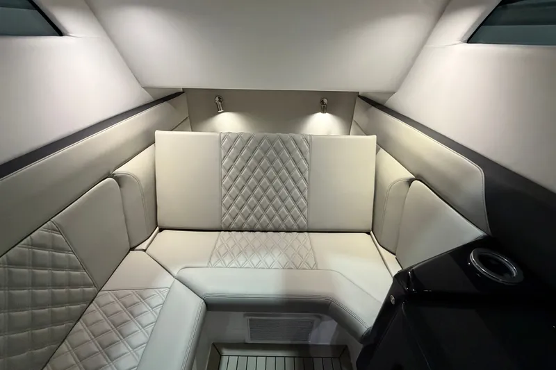 Slide: The Image of Luxurious interior of 2027 Nor-Tech 450 Sport boat with quilted seating and ambient lighting. - 51