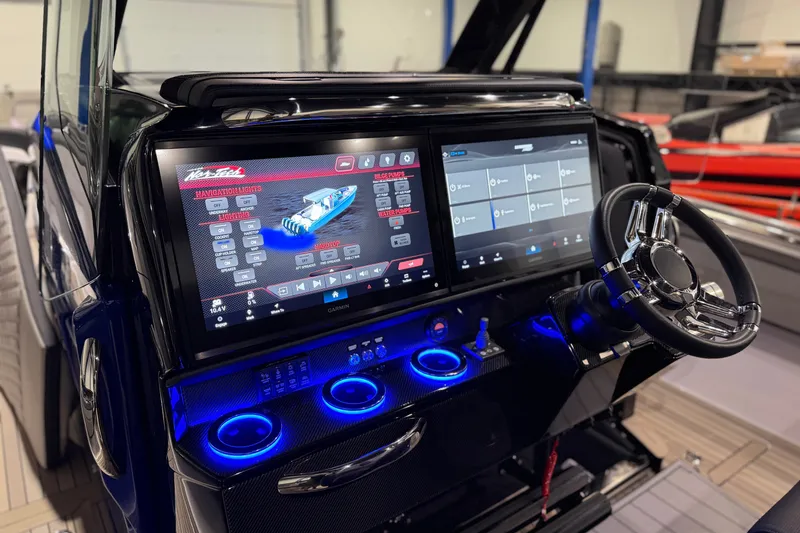 Slide: The Image of Dashboard of a 2027 Nor-Tech 450 Sport boat with advanced navigation screens. - 29