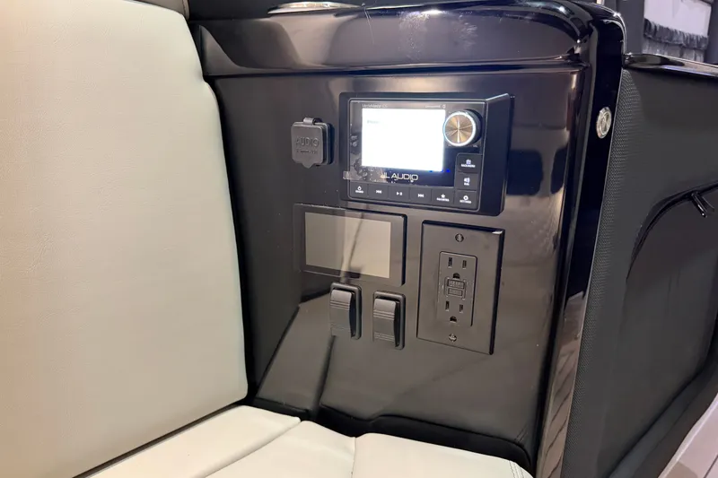 Slide: The Image of Control panel of 2027 Nor-Tech 450 Sport boat with audio system and power outlets. - 52