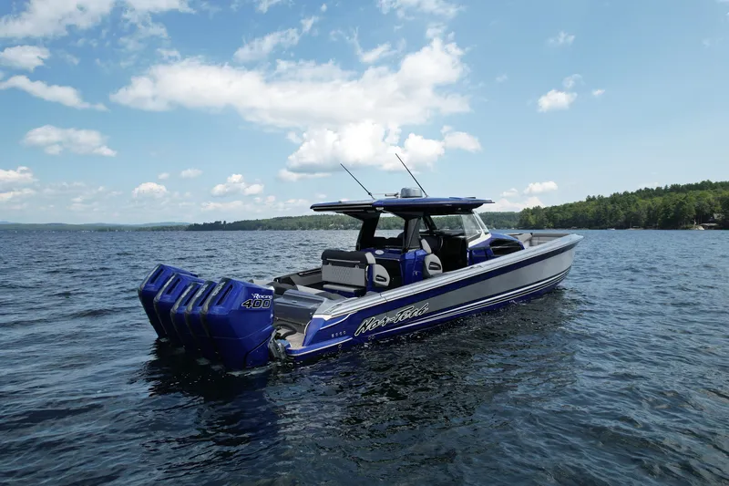 The Image of 2027 Nor-Tech 450 Sport boat on a lake under a clear blue sky. - 0