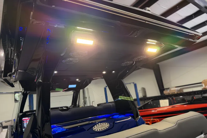 Slide: The Image of Interior view of 2027 Nor-Tech 450 Sport boat with illuminated ceiling lights. - 43