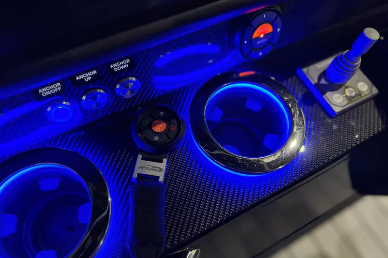 Slide: The Image of Control panel of 2027 Nor-Tech 450 Sport boat with illuminated cup holders and buttons. - 32
