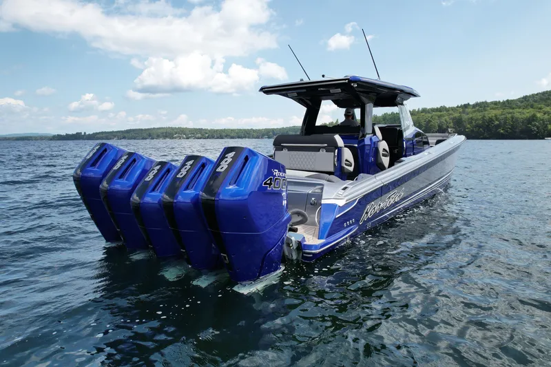 Slide: The Image of 2027 Nor-Tech 450 Sport boat with multiple engines on a serene lake. - 13