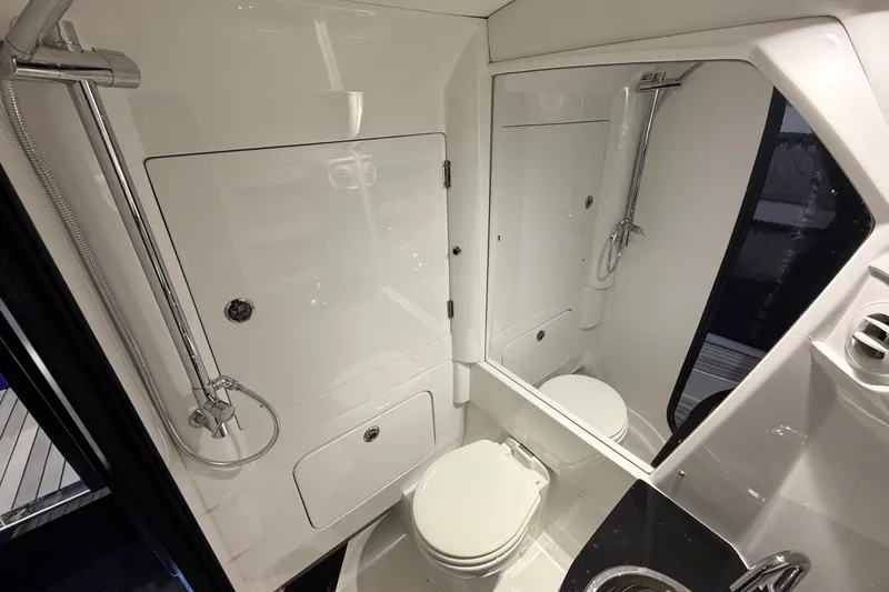Slide: The Image of Luxurious bathroom in 2027 Nor-Tech 450 Sport boat, featuring modern fixtures and sleek design. - 55
