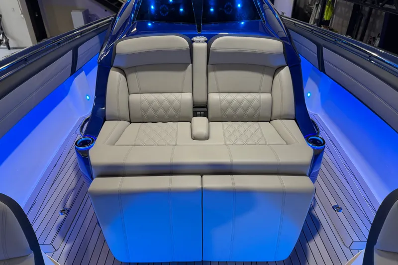 Slide: The Image of Luxurious seating on 2027 Nor-Tech 450 Sport boat with ambient blue lighting. - 22