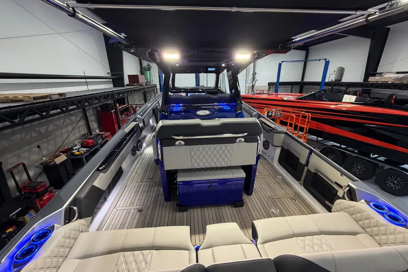 Slide: The Image of Interior view of a 2027 Nor-Tech 450 Sport boat, showcasing luxurious seating and modern design. - 57