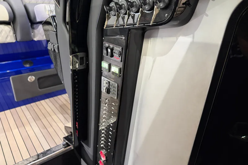 Slide: The Image of Control panel of 2027 Nor-Tech 450 Sport boat, featuring switches and keys. - 48