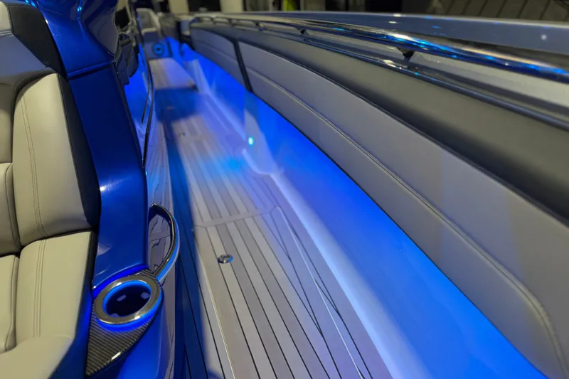 Slide: The Image of Interior view of 2027 Nor-Tech 450 Sport boat with blue LED lighting and sleek seating. - 26