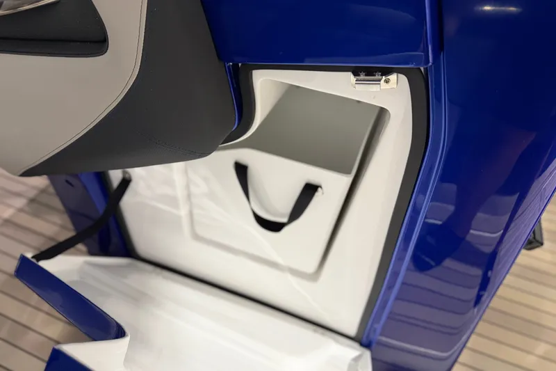 Slide: The Image of Open storage compartment on 2027 Nor-Tech 450 Sport boat, featuring sleek blue and white design. - 39