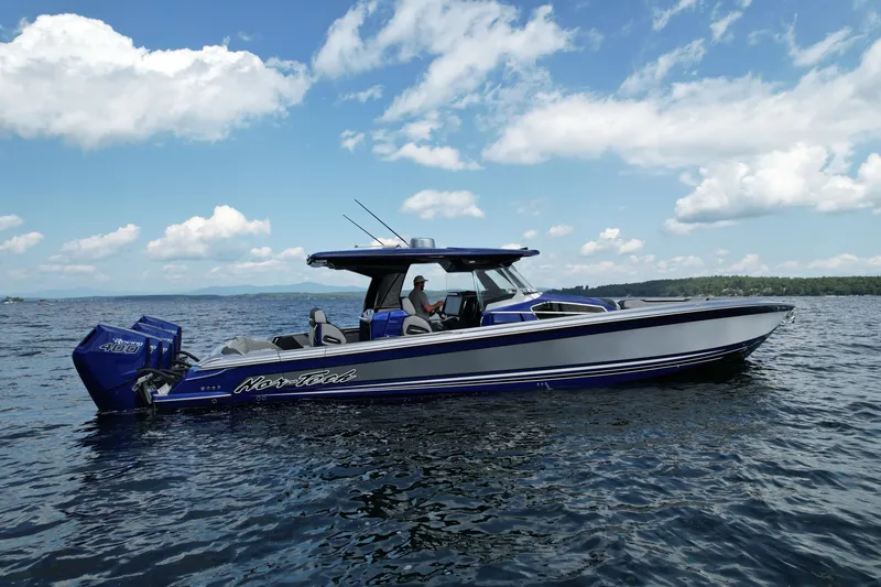 Slide: The Image of 2027 Nor-Tech 450 Sport boat on open water under a blue sky. - 15
