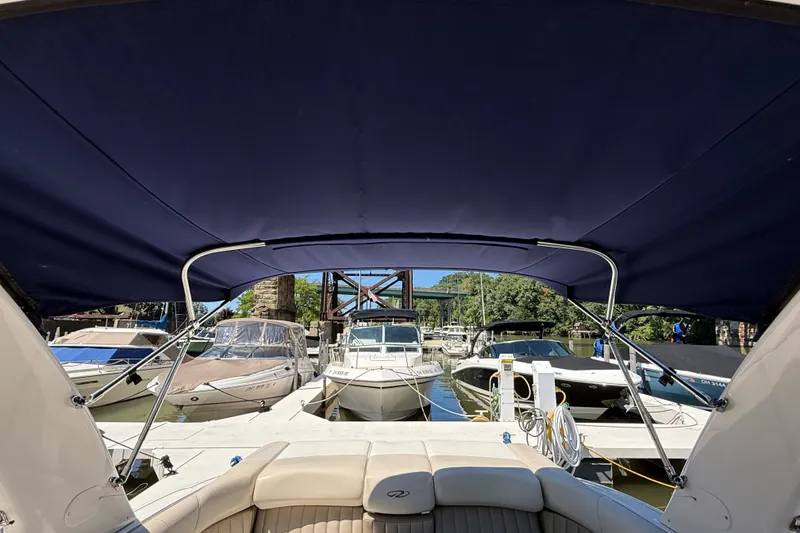 Slide: The Image of 2011 Regal 2700 ES Bowrider docked at marina with canopy view. - 34