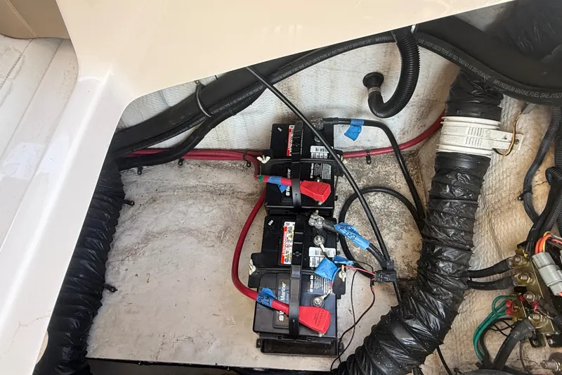 Slide: The Image of Battery compartment of a 2011 Regal 2700 ES Bowrider with wiring and connections. - 38