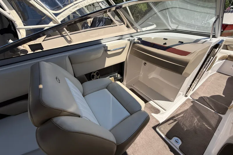 Slide: The Image of 2011 Regal 2700 ES Bowrider interior with beige seating and dashboard. - 13