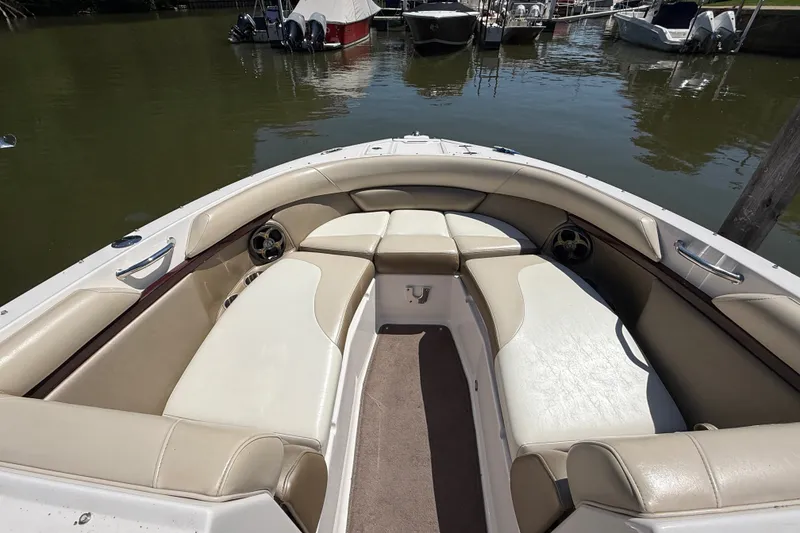 Slide: The Image of 2011 Regal 2700 ES Bowrider with spacious seating, docked on calm water. - 26