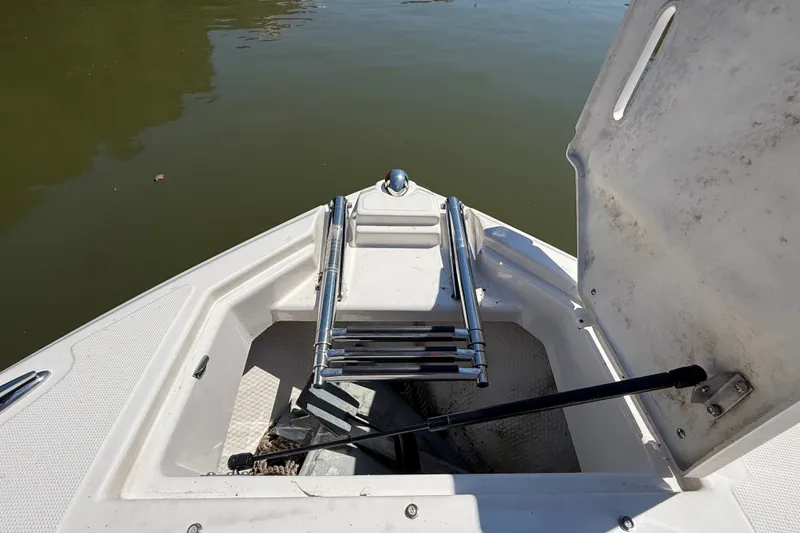 Slide: The Image of Bow storage compartment of 2011 Regal 2700 ES Bowrider with ladder and anchor. - 30