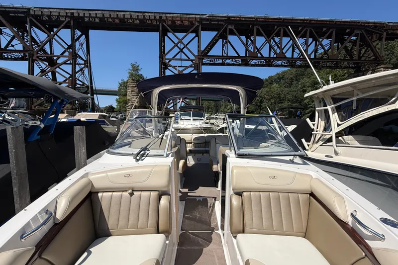 Slide: The Image of 2011 Regal 2700 ES Bowrider docked under a steel bridge on a sunny day. - 31