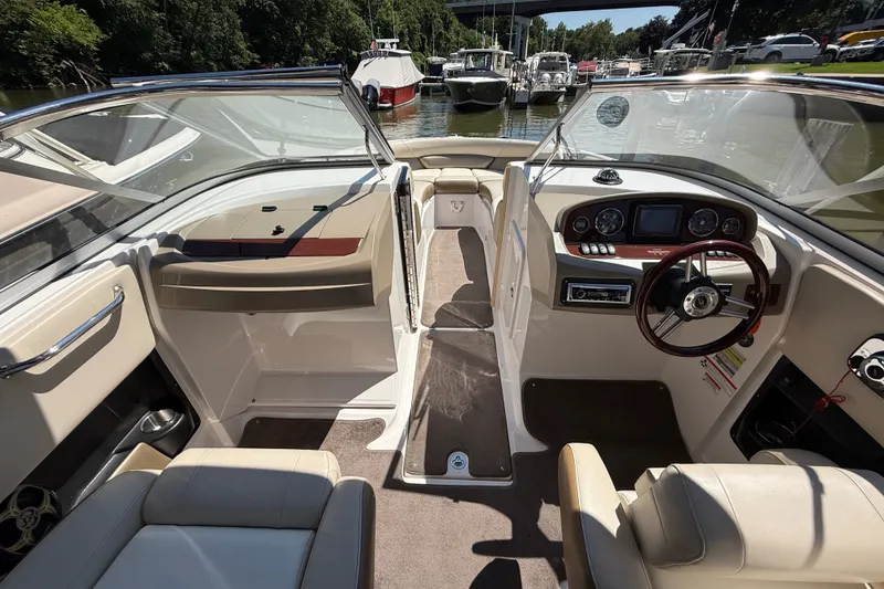 Slide: The Image of Interior view of 2011 Regal 2700 ES Bowrider boat, featuring steering wheel and seating. - 14