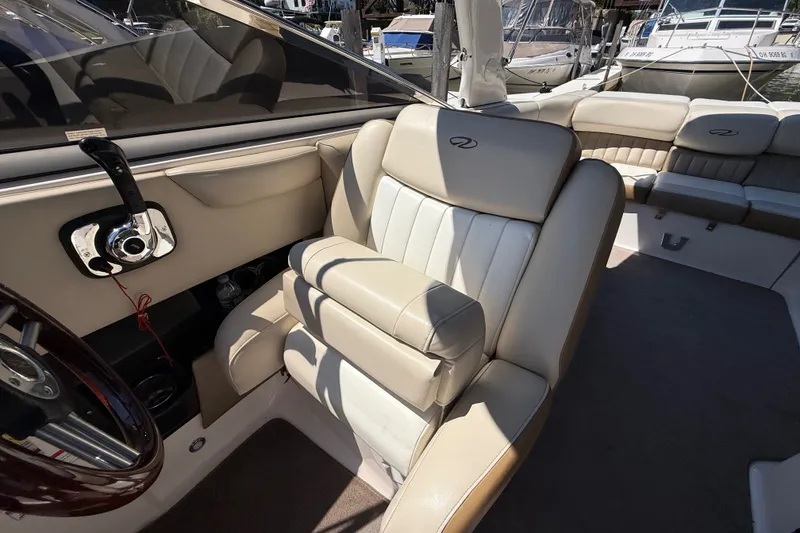 Slide: The Image of Interior of 2011 Regal 2700 ES Bowrider with beige leather seating and steering wheel. - 15