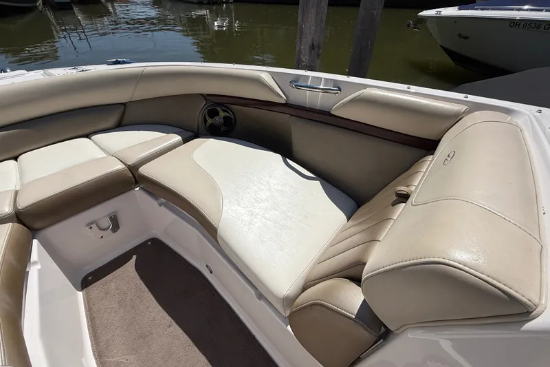 Slide: The Image of 2011 Regal 2700 ES Bowrider interior with beige seating and water view. - 28