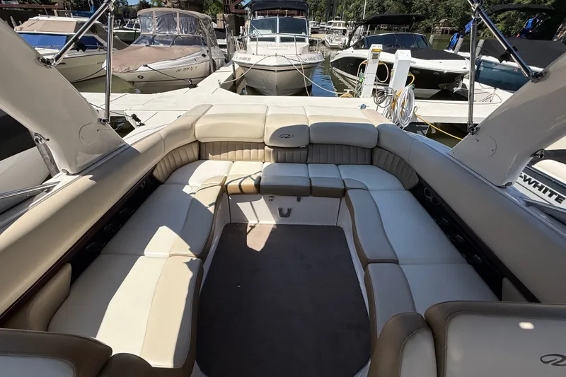 Slide: The Image of 2011 Regal 2700 ES Bowrider interior with spacious seating at marina. - 33