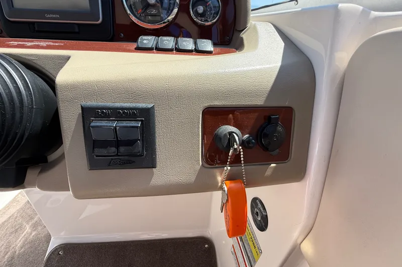 Slide: The Image of Dashboard controls of a 2011 Regal 2700 ES Bowrider boat with ignition key. - 19