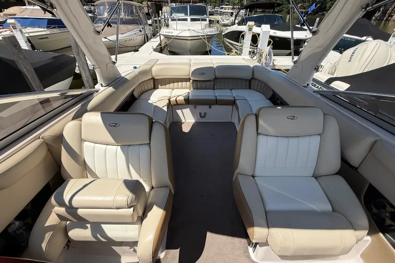 Slide: The Image of 2011 Regal 2700 ES Bowrider interior with beige seating at marina. - 32