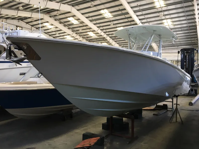 Slide: The Image of A 2017 Contender 32 ST boat is on stands in a warehouse. - 20