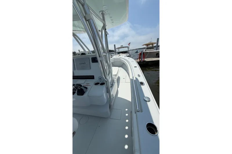 Slide: The Image of 2017 Contender 32 ST boat interior with Garmin equipment, docked by the water. - 15