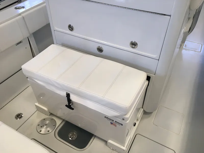 Slide: The Image of The image shows the interior of a 2017 Contender 32 ST boat with a white bench seat and storage. - 27