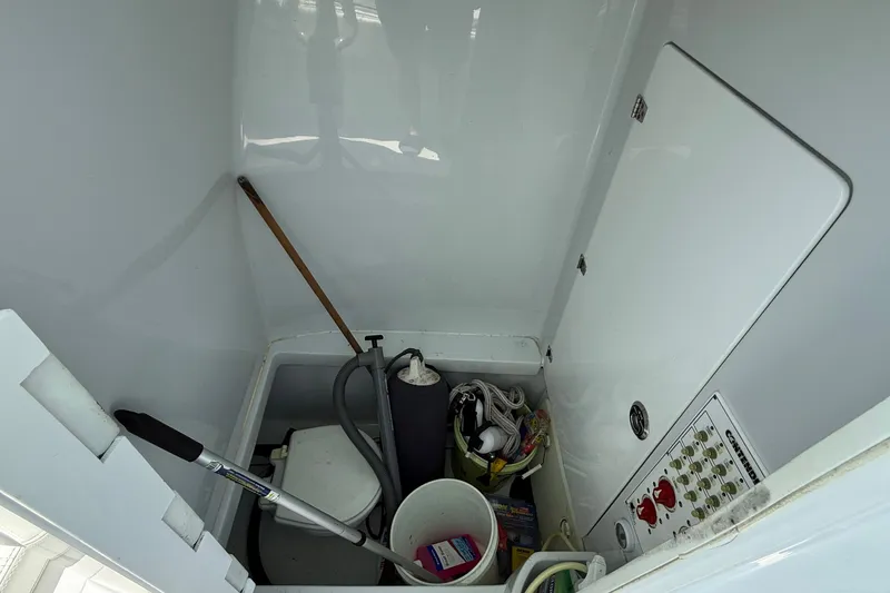 Slide: The Image of Storage compartment of a 2017 Contender 32 ST boat with various equipment and tools. - 17