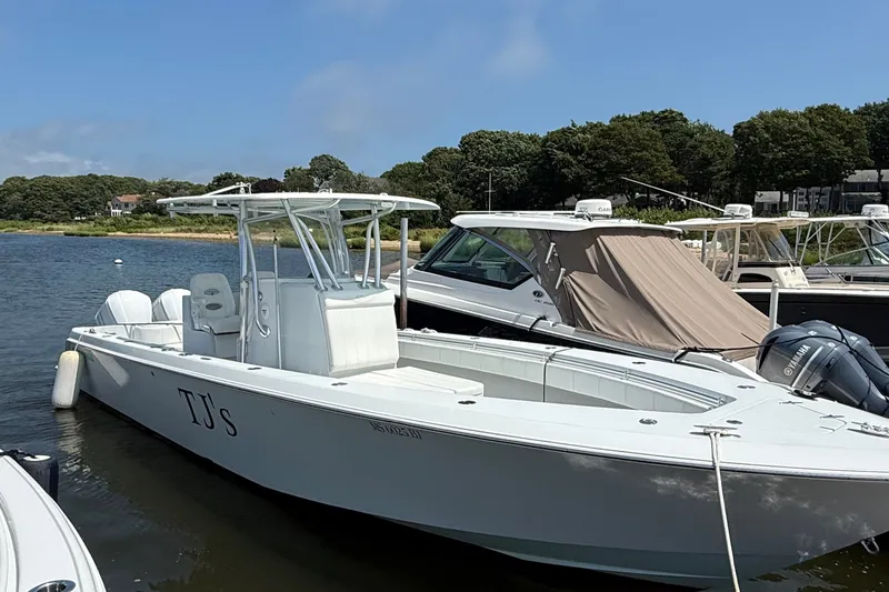 The Image of 2017 Contender 32 ST boat docked, featuring sleek design and Yamaha engines. - 0