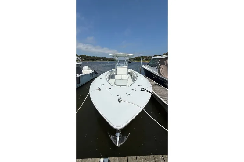 Slide: The Image of 2017 Contender 32 ST boat docked on a sunny day, showcasing sleek design and spacious deck. - 32