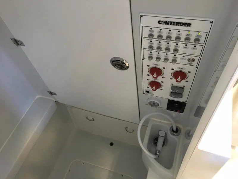 Slide: The Image of The image shows the control panel of a 2017 Contender 32 ST boat. - 30