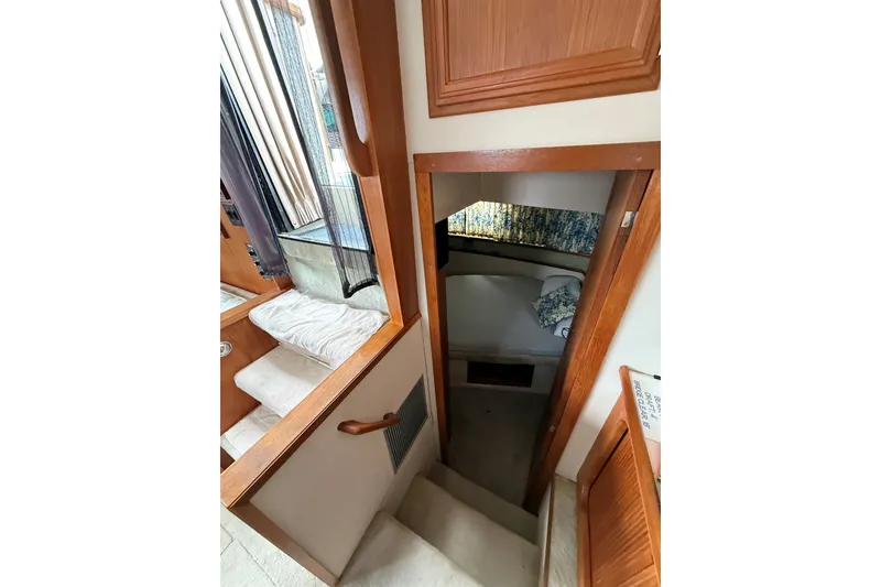 Slide: The Image of 1988 Carver 38 Aft Cabin Motor Yacht interior with stairs leading to cozy cabin. - 28