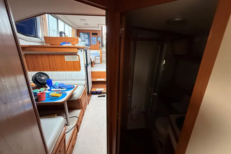 Slide: The Image of Interior of 1988 Carver 38 Aft Cabin Motor Yacht with dining area and bathroom. - 42