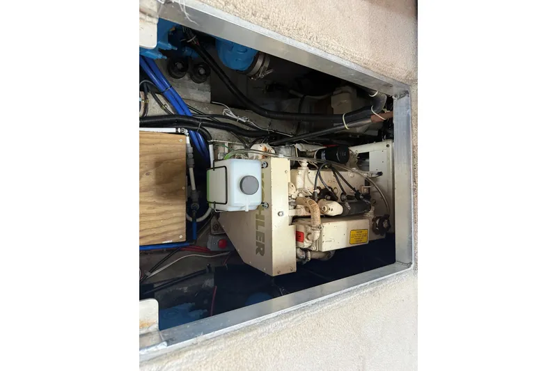 Slide: The Image of Engine compartment of 1988 Carver 38 Aft Cabin Motor Yacht, showcasing mechanical components. - 43