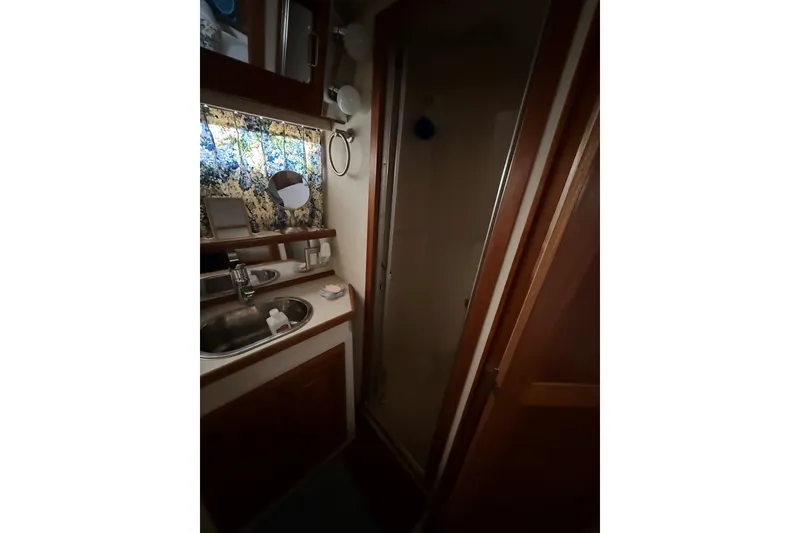 Slide: The Image of 1988 Carver 38 Aft Cabin Motor Yacht bathroom with sink, mirror, and shower. - 32
