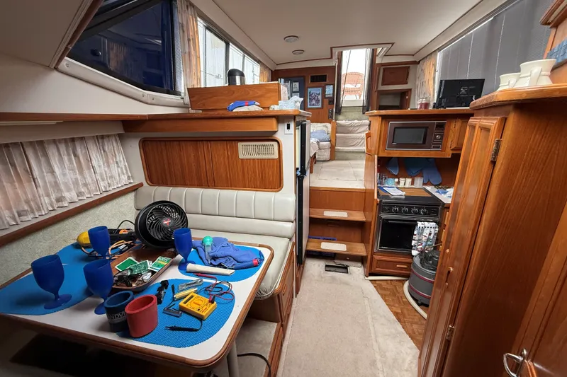 Slide: The Image of Interior of 1988 Carver 38 Aft Cabin Motor Yacht with dining area and kitchen. - 38