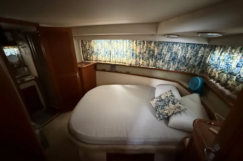 Slide: The Image of Cozy bedroom in 1988 Carver 38 Aft Cabin Motor Yacht with floral curtains. - 29