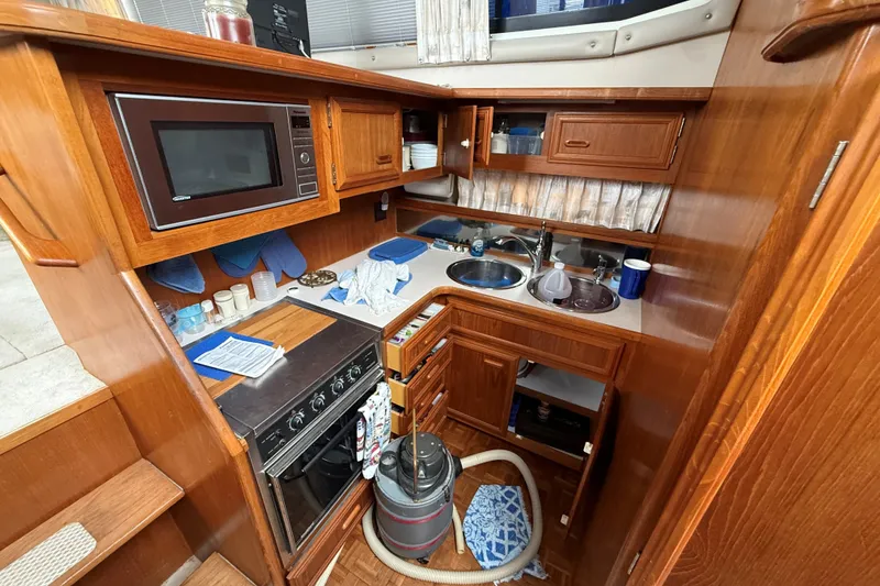 Slide: The Image of 1988 Carver 38 Aft Cabin Motor Yacht kitchen with wood cabinetry and appliances. - 36