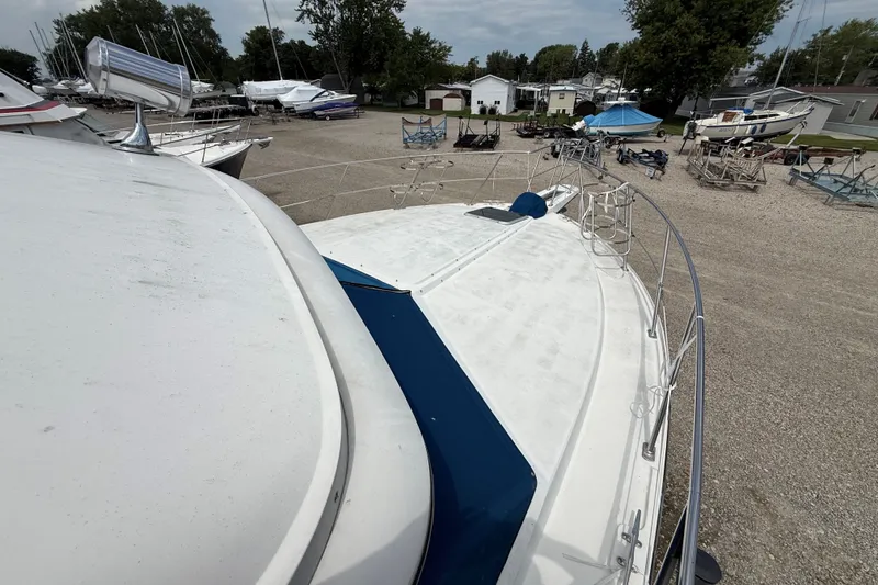 Slide: The Image of 1988 Carver 38 Aft Cabin Motor Yacht on dry dock, surrounded by other boats. - 10